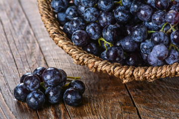 Juicy black grapes in basket