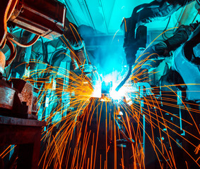 Team welding Robot movement Industrial automotive part in factory