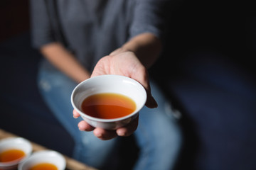 Female hands holding cup with tea