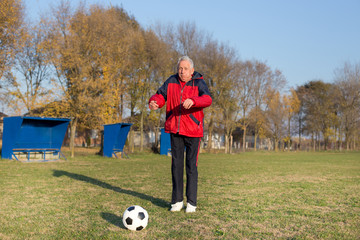 Senior man playing football