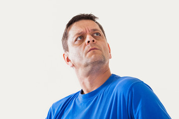 Obraz premium Portrait of a man of thoughtfully looks upwards - isolated