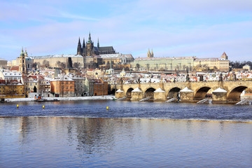 Christmas snowy Prague Lesser Town with gothic Castle and Charles Bridge, Czech Republic