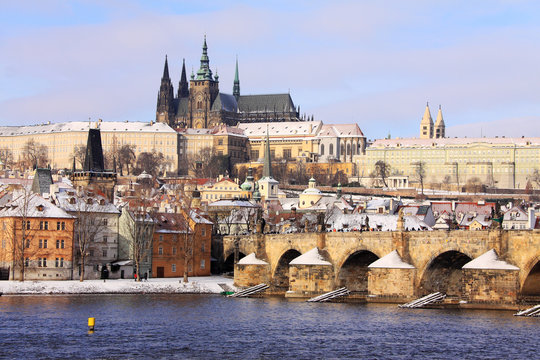 Christmas snowy Prague Lesser Town with gothic Castle and Charles Bridge, Czech Republic