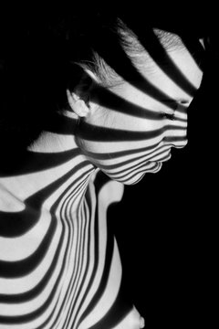 The face of woman with black and white zebra stripes
