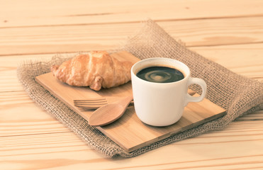 Coffee cup and croissant