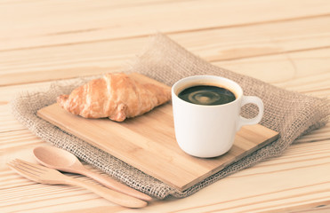 Coffee cup and croissant