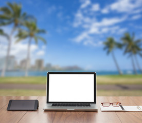 Blank screen laptop computer with sea background