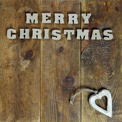 text Merry Christmas on old wooden background
