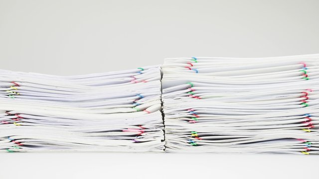 Stack of receipt overload with colorful paper clip time lapse