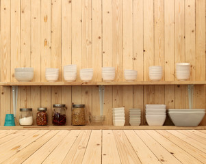 Fototapeta na wymiar White ceramic kitchenware on the wooden shelf