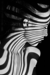 The face of woman with black and white zebra stripes