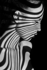 Fototapeta na wymiar The face of woman with black and white zebra stripes