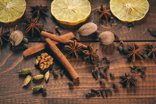 Collection of spices for mulled wine and pastry on the wooden table