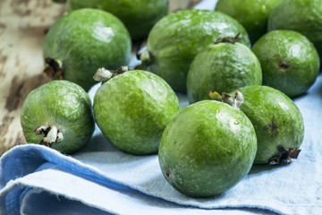 Ripe green feijoa on a blue linen napkin, selective focus