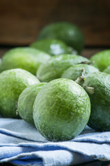 Ripe green feijoa on a blue linen napkin, selective focus