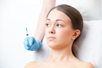  woman  looks frightened at a syringe