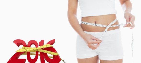 Composite image of midsection of woman measuring waist