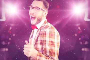 Composite image of geeky hipster pointing at camera