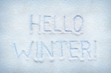 Text HELLO WINTER written on snow. Horizontal postcard.