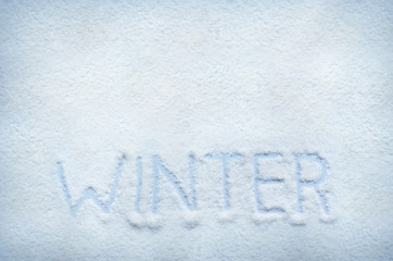 Text WINTER written on snow. Horizontal postcard with space for lettering, copy or texting.