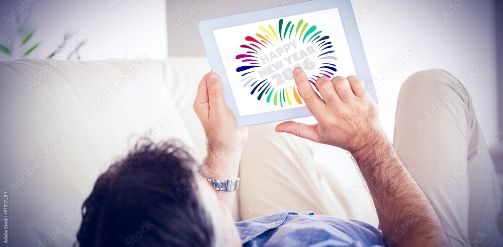 Poster composite image of man laying on sofa using a tablet pc