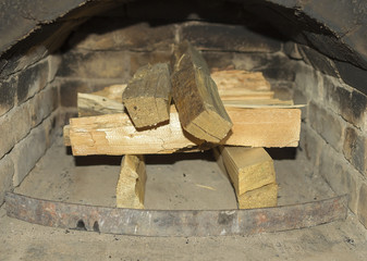 Firewood in the a rustic fireplace.