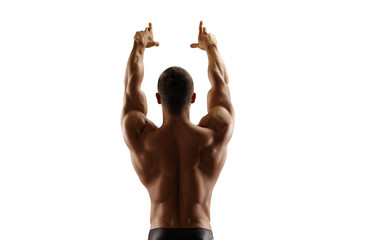 Muscular man standing with his back lifting his hands up. Isolate.