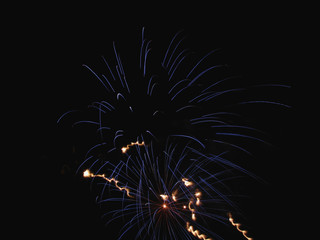 Colorful fireworks of various colors light up the night sky