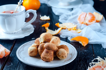 teacup with tea and biscuits on a black table