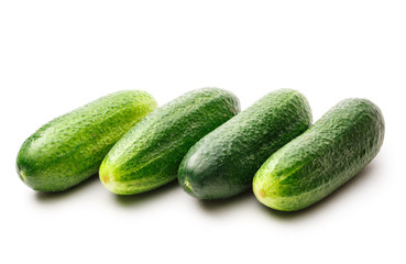 Fresh green cucumbers on white