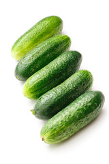 Fresh green cucumbers on white