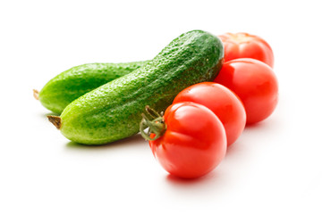 Fresh cucumbers and tomatoes on white