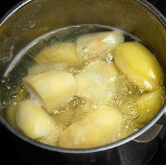 Potatoes boiling in saucepan