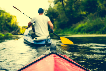 nose of canoe floating behind rower