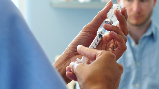 Exam: Nurse Pulls A Dose Of Vaccine Into Syringe