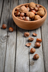 Hazelnuts and walnuts in a wooden bowl 