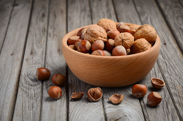 Hazelnuts and walnuts in a wooden bowl 