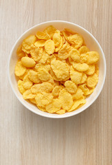 Yellow corn flakes in white bowl on