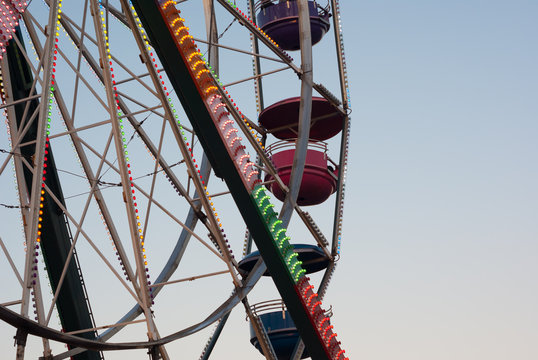 amusement park carousel big wheel on blue sky