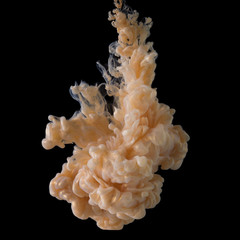 Golden paint cloud with glitter in water isolated on black
