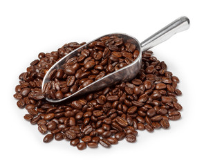 Metal scoop with roasted coffee beans on coffee heap isolated