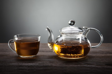 teapot and cup of tea on wooden table