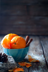 Tangerine in scarf over wooden background