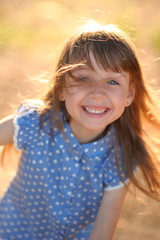 portrait of little girl outdoors in summer