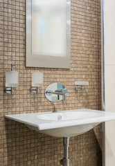 Washbasin and mirror in bathroom interior