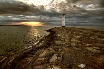 Obraz premium Lighthouse windmill Stawa Mlyny, Swinoujscie, Baltic Sea, Poland.