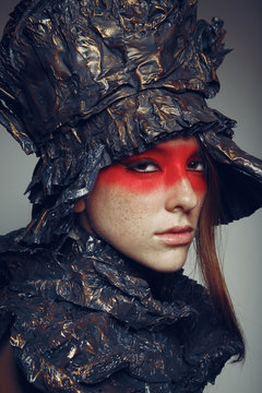 Portrait of beautiful woman with red make-up with metal headwear
