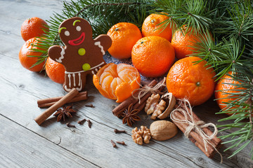 Christmas table with tangerines , gingerbread and fir branches