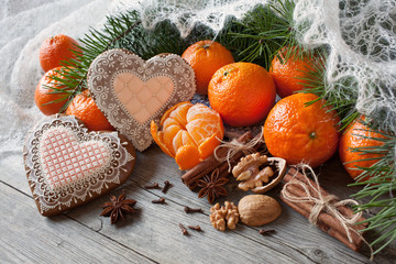 Christmas table with tangerines , gingerbread and fir branches