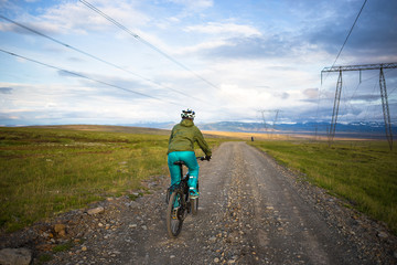 Fototapeta premium Happy biker on backdrop of volcanic mountains in Iceland